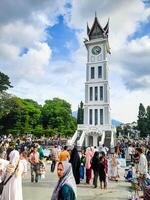 Bukittinggi, Indonesia - April 28, 2024. Bukittinggi Clock Tower or Jam Gadang, one of the world's historical heritages and a tourist destination in Bukittinggi City photo