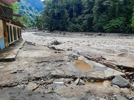 Tanah Datar, Indonesia - May 12, 2024. The back of a building affected by cold lava flash floods, a natural disaster in Lembah Anai, Sepuluh Koto District, Tanah Datar Regency, West Sumatra, Indonesia photo