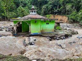 Tanah Datar, Indonesia - May 12, 2024. condition of the mosque affected by cold lava flash floods. Natural Disaster in Lembah Anai, Sepuluh Koto District, Tanah Datar, West Sumatra, Indonesia photo