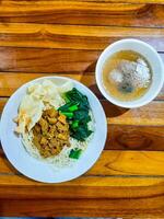 chicken noodle meatball or mie ayam bakso. popular street food in Indonesia photo