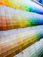 paper color palettes on a shelf in a wall paint supply store, guide of paint samples catalog photo