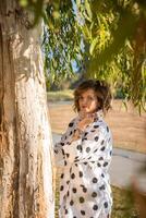 Fashion shot of a beautiful boho style girl on nature background. Boho, hippie. photo