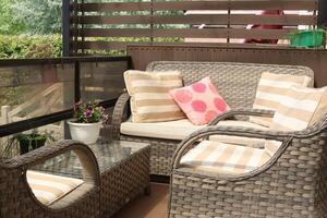 Wicker patio furniture on timber deck in sunny summer day. photo