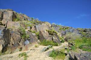 Petroglyphs within the Archaeological Landscape of Tamgaly. Almaty area, Kazakhstan photo