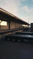 Trailer Parked Next to Loading Dock in Parking Lot video