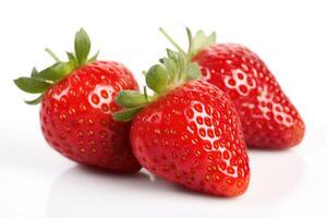 Three red ripe fresh strawberries with strawberry leaves on isolated white background. Organic farm food, fresh market, supermarket, healthy products. photo