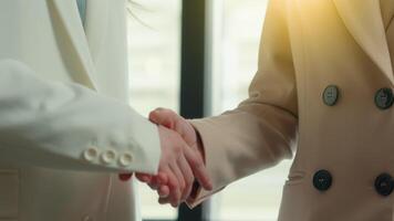 Cropped view close up two business women handshaking in office unity teamwork deal success partnership female shaking hands formal greeting insurance banking invest handshake workers partners hire job video