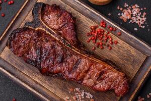 Delicious juicy beef tbone steak with salt, spices and herbs photo