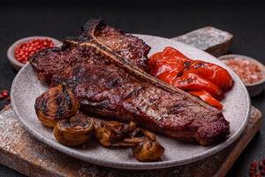 Delicious juicy beef tbone steak with salt, spices and herbs photo