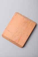 Empty wooden cutting board on gray textured concrete background photo