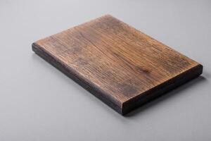 Empty wooden cutting board on gray textured concrete background photo