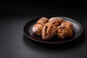 Fresh baked bread buns with salt, spices, seeds and grains photo