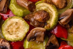 Delicious fresh grilled vegetables zucchini, bell peppers, mushrooms and onions photo