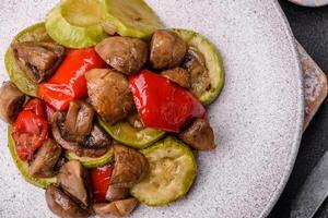 Delicious fresh grilled vegetables zucchini, bell peppers, mushrooms and onions photo