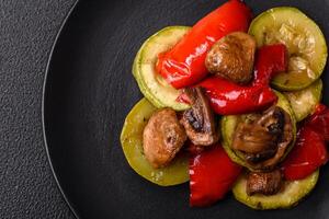 Delicious fresh grilled vegetables zucchini, bell peppers, mushrooms and onions photo