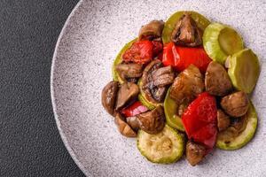 Delicious fresh grilled vegetables zucchini, bell peppers, mushrooms and onions photo