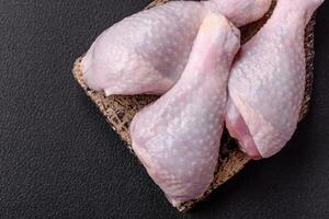 Fresh raw chicken legs with salt and spices photo