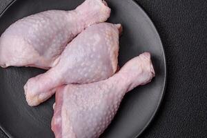 Fresh raw chicken legs with salt and spices photo