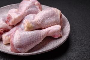 Fresh raw chicken legs with salt and spices photo