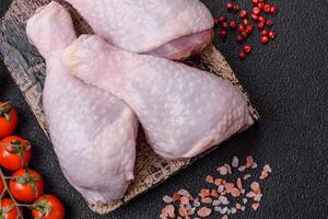 Fresh raw chicken legs with salt and spices photo