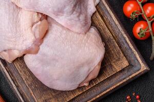 Fresh raw chicken thighs with salt and spices photo