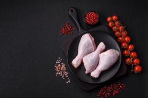 Fresh raw chicken legs with salt and spices photo