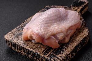 Fresh raw chicken thighs with salt and spices photo