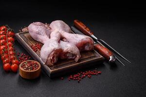 Fresh raw chicken legs with salt and spices photo