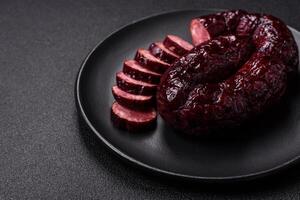 Delicious black blood sausage or black pudding with spices and herbs photo