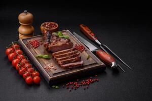 Delicious juicy beef steak on the bone, tomahawk with salt, spices and herbs photo