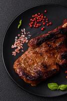 Delicious juicy beef steak on the bone, tomahawk with salt, spices and herbs photo