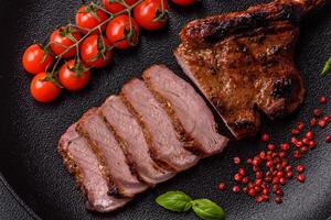 Delicious juicy beef steak on the bone, tomahawk with salt, spices and herbs photo