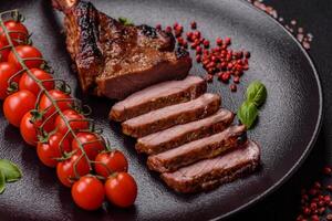 Delicious juicy beef steak on the bone, tomahawk with salt, spices and herbs photo