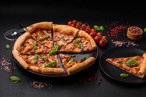 Delicious pizza with sausage, cheese, tomatoes, salt, spices and herbs photo