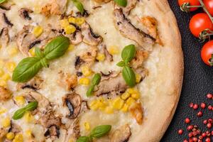 Delicious pizza with corn, cheese, tomatoes and mushrooms, salt, spices and herbs photo