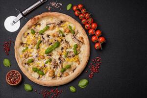 Delicious pizza with corn, cheese, tomatoes and mushrooms, salt, spices and herbs photo