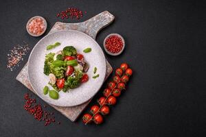 Delicious fresh juicy salad with quail eggs, cherry tomatoes, lettuce leaves photo