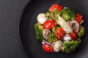 Delicious fresh juicy salad with quail eggs, cherry tomatoes, lettuce leaves photo