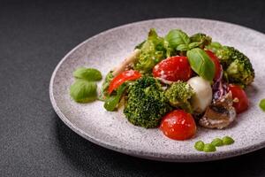 Delicious fresh juicy salad with quail eggs, cherry tomatoes, lettuce leaves photo