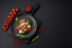 Delicious fresh juicy salad with quail eggs, cherry tomatoes, lettuce leaves photo