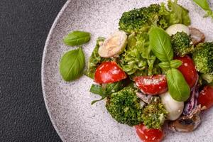 Delicious fresh juicy salad with quail eggs, cherry tomatoes, lettuce leaves photo