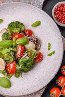 Delicious fresh juicy salad with quail eggs, cherry tomatoes, lettuce leaves photo