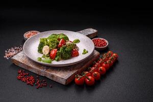 Delicious fresh juicy salad with quail eggs, cherry tomatoes, lettuce leaves photo