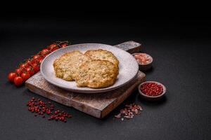 Delicious fried minced chicken cutlets with salt, spices and herbs photo
