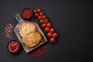 Delicious fried minced chicken cutlets with salt, spices and herbs photo