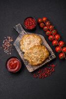 Delicious fried minced chicken cutlets with salt, spices and herbs photo