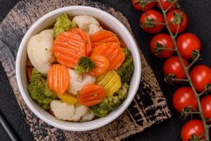 Delicious fresh vegetables broccoli, cauliflower, carrots steamed with salt photo