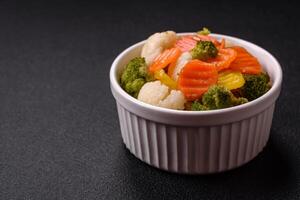 Delicious fresh vegetables broccoli, cauliflower, carrots steamed with salt photo