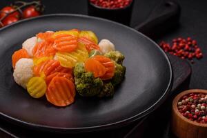 Delicious fresh vegetables broccoli, cauliflower, carrots steamed with salt photo