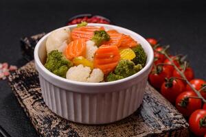 Delicious fresh vegetables broccoli, cauliflower, carrots steamed with salt photo